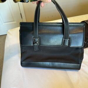 Sleek Black Leather-Trimmed Coach Tote with Contrast Stitching
